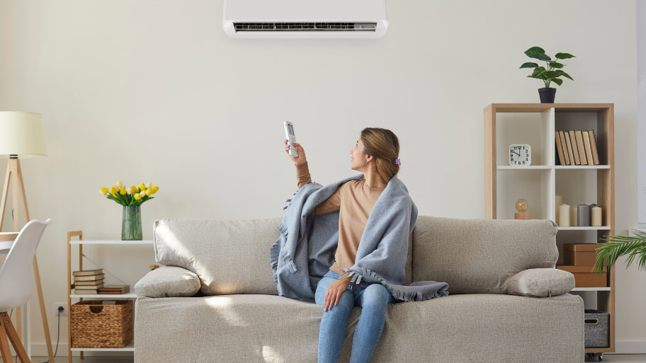 Woman Turning On HVAC- HVAC Installation Guide